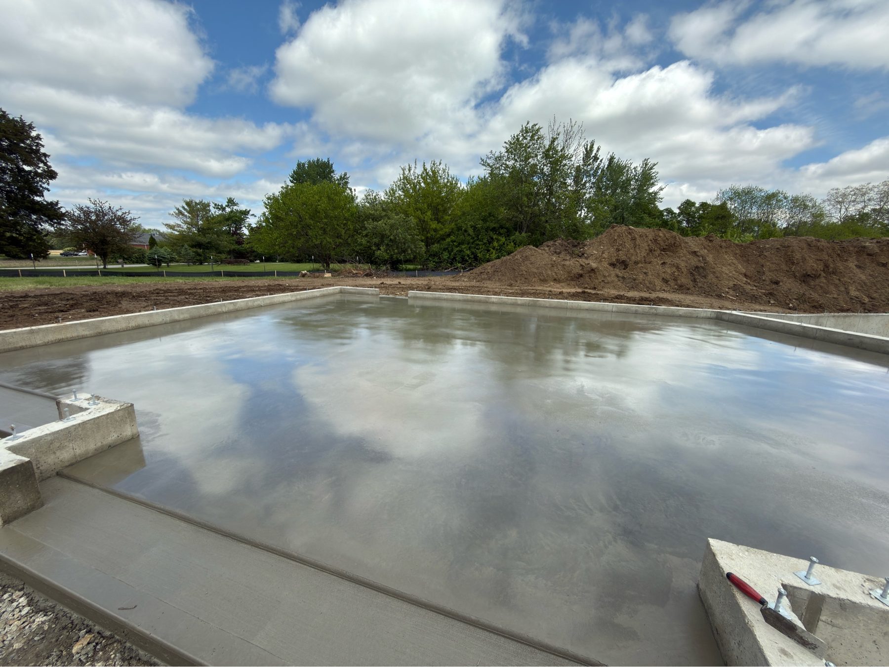 Freshly poured concrete foundation slab on a residential site